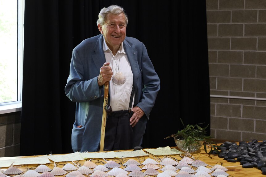 Father Michael Tate with scallop shells.