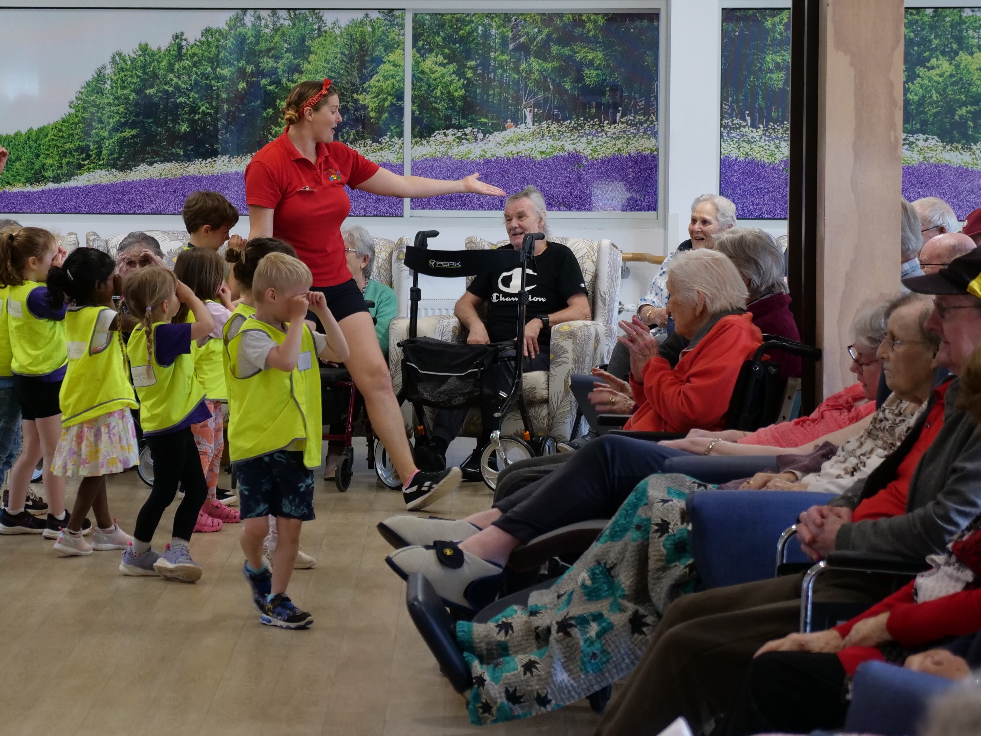 kinder aged kids singing and dancing at an aged care facility