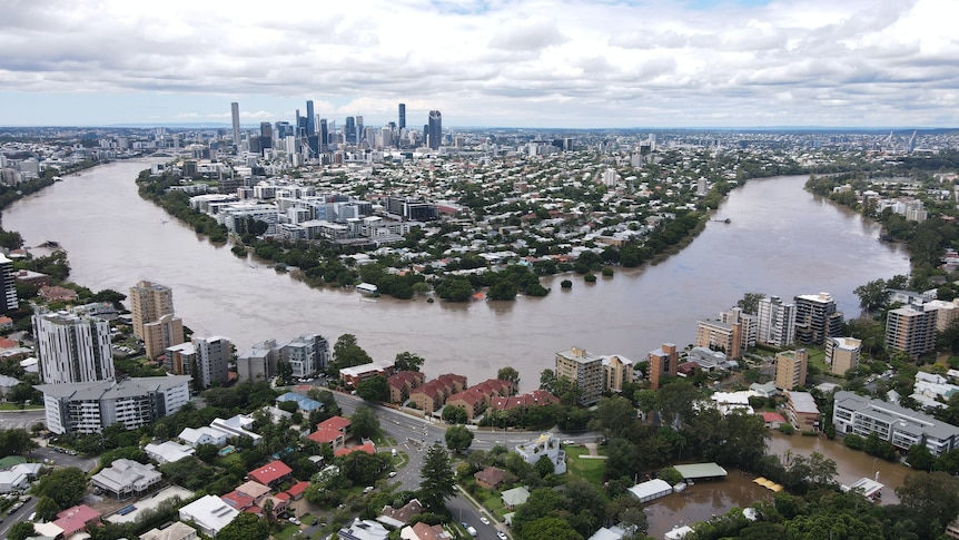 View of Brisbane River in flood CBD in background