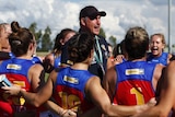 Craig Starcevich sings the Lions' theme song in the middle of the AFLW huddle