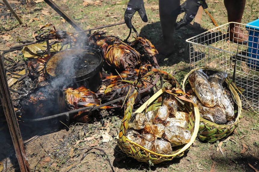 Traditional Fijian food is cooked on a stove and wrapped in aluminium foil.