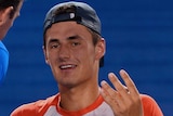 Bernard Tomic speaks to trainers during first round