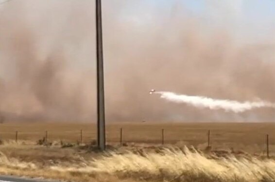 A water bomber dumps a load near Port Wakefield.