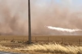 A water bomber dumps a load near Port Wakefield.