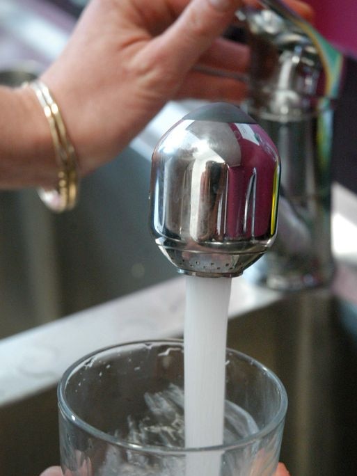 Tap water pouring into a glass.