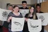 Three teenaged students and two adults holding up calcio bags with indigenous stencil designed printed on them