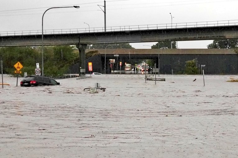 Two cars swept down Kedron Brook at Toombul shopping centre.