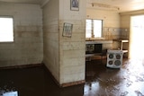 A muddy house after the flood receded, Nauiyu
