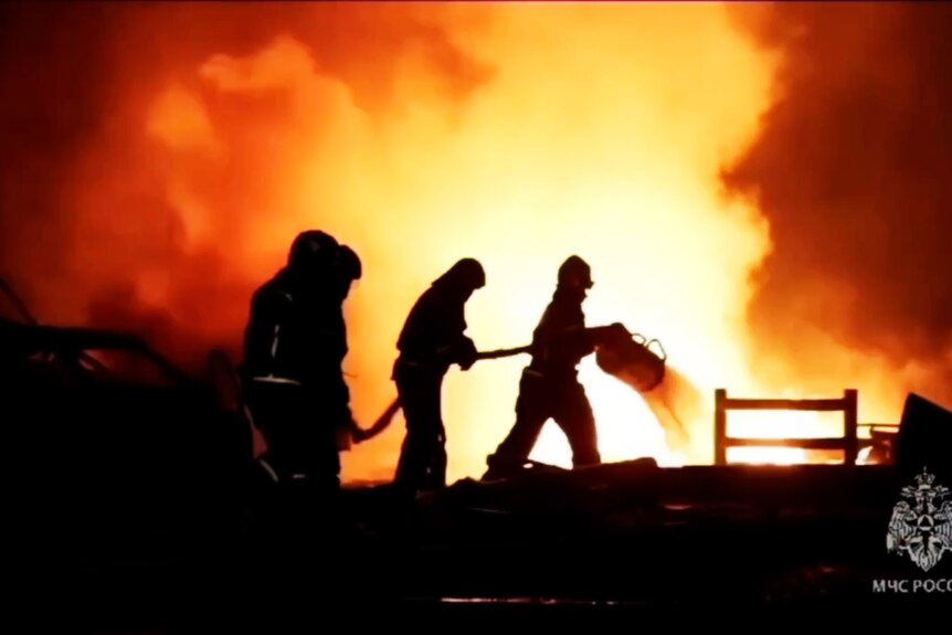 Picture of firefighter silhouetted against fire  