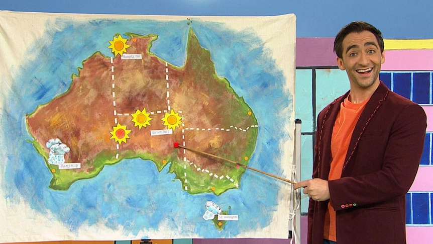Matt as a weather presenter standing in front of a map of Australia