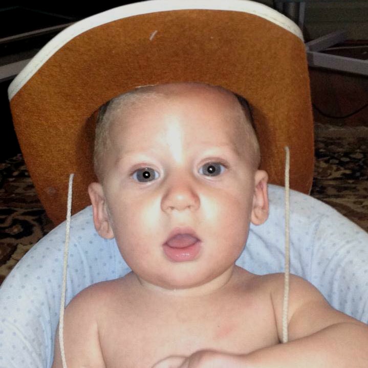 A toddler wearing a hat.