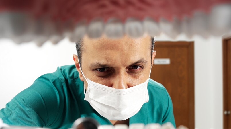 Dentist looking to a patient's mouth