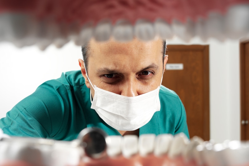 Dentist looking to a patient's mouth