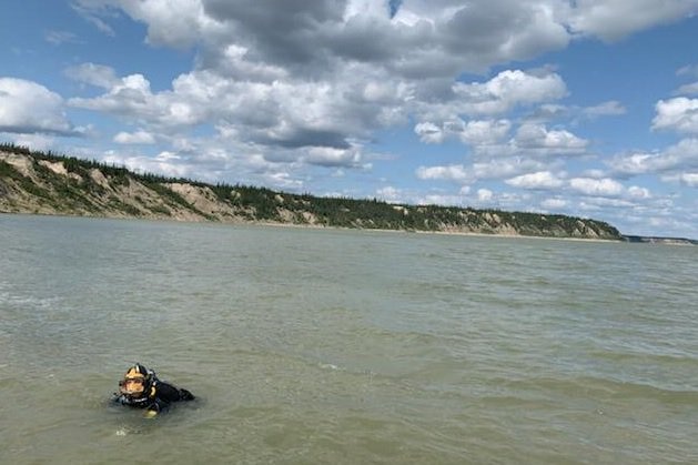 A police diver searching Canada's Nelson River for evidence.