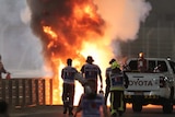 Flames seen from the crash scene after Haas' Romain Grosjean crashed out