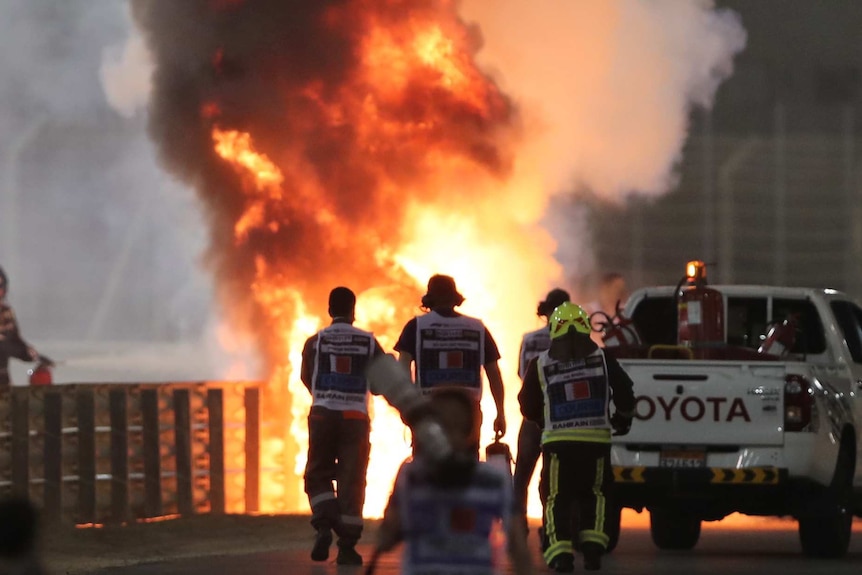 Flames seen from the crash scene after Haas' Romain Grosjean crashed out