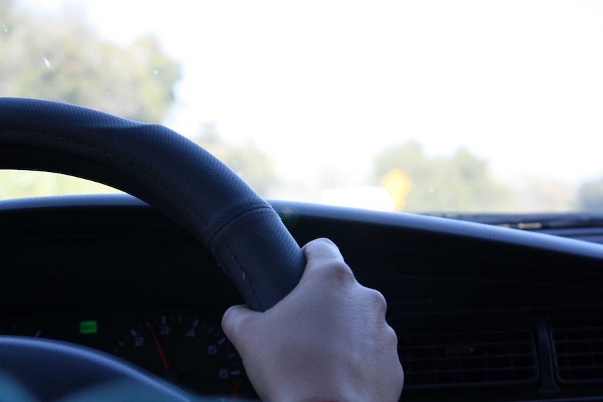 Hand on a steering wheel