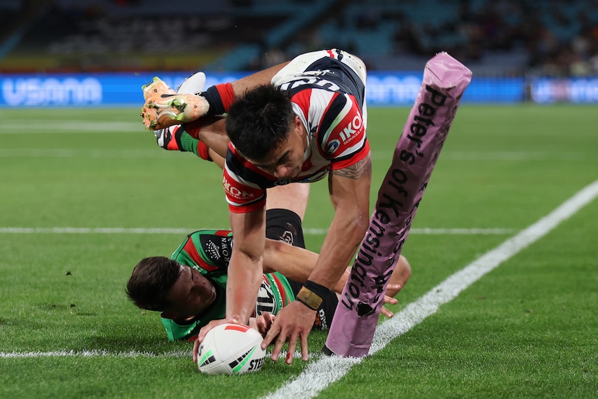 A man scores a try in a rugby league match