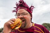 Barry Harwood enjoys a burger ahead of the State of Origin.