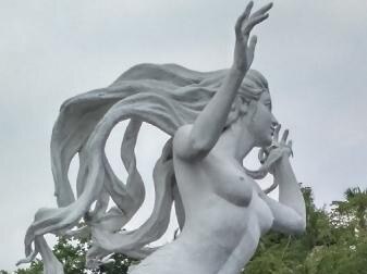 Large topless mermaid statue with hair flowing