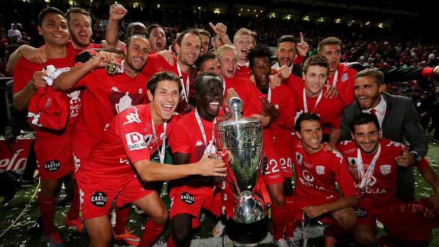 Adelaide United celebrates with FFA Cup trophy
