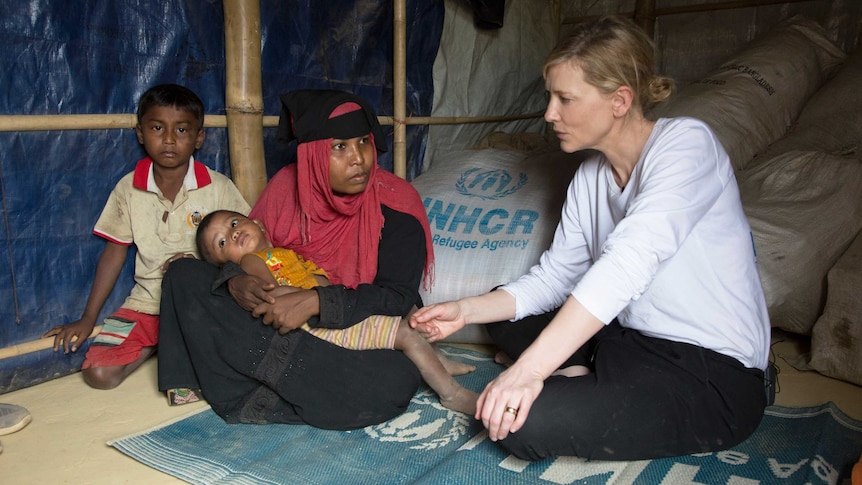 Blanchett sits in a shelter with refugee Jhura and her two children.