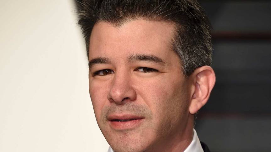Uber CEO Travis Kalanick glares at the camera while wearing a black suit and tie at the vanity fair oscars event