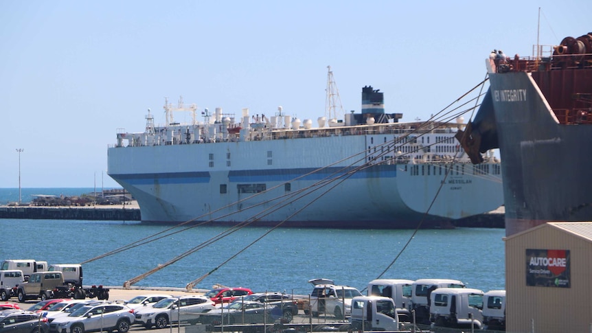 The carrier sits in dock, next to a jetty. The Key Integrity carrier, also in dock, is in the foreground.