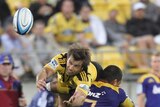 Conrad Smith is tackled by Alando Soakai during the Super Rugby season opener.