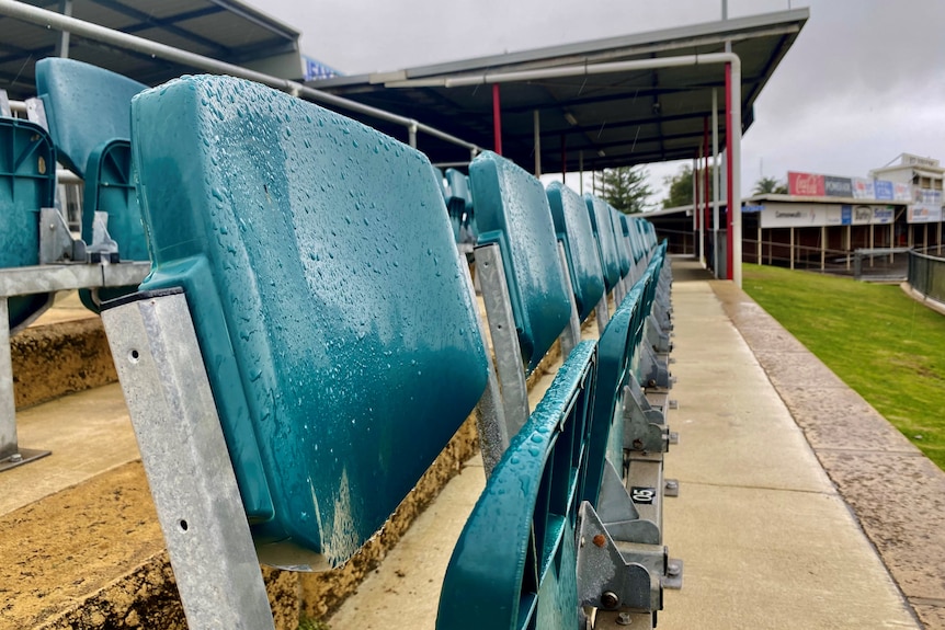 Wet empty seats at a football ground