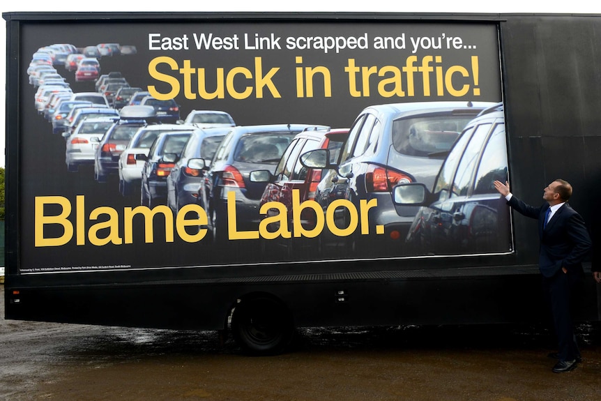 Tony Abbott unveils road billboard