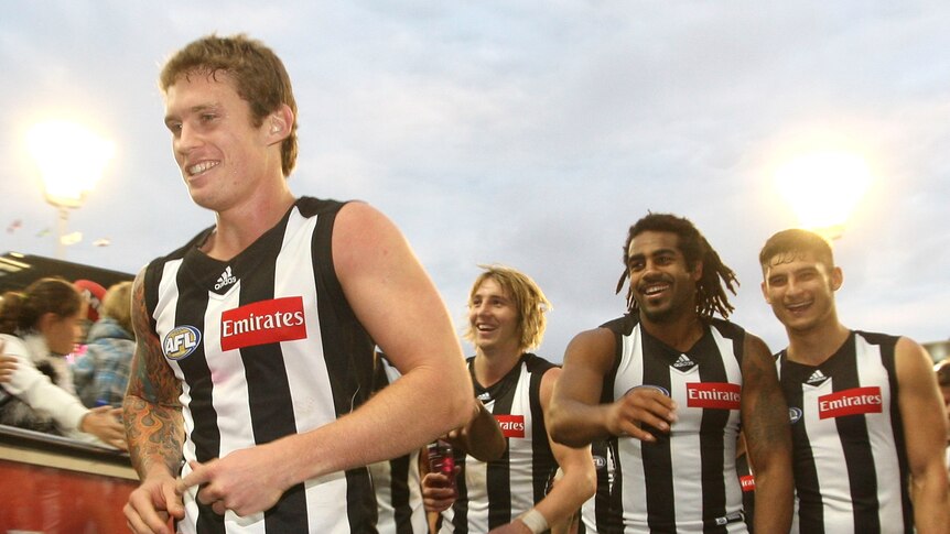 Collingwood's Dayne Beams leaves the MCG with team-mates after a match against West Coast in 2011.
