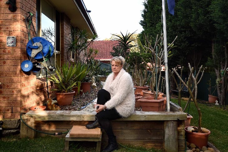 Karen Nettleton sits in the garden of her home.