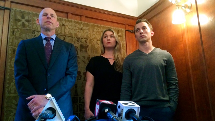 Denise Huskins and her boyfriend Aaron Quinn stand with their attorney at a press conference