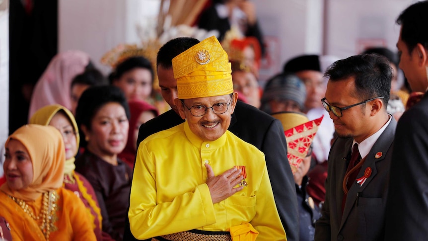 BJ Habibie wearing bright yellow ceremonial clothing.