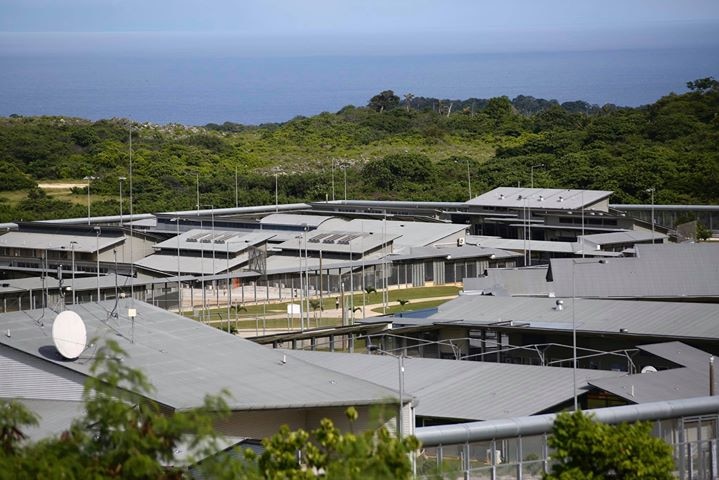 A complex with a high security fence and satellite dishes.