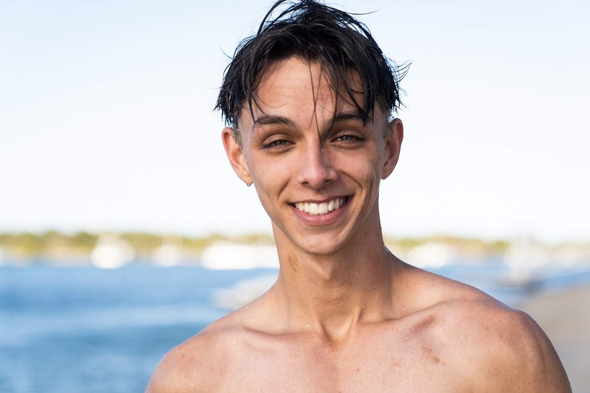 Smiling photo of Connor Phillips on the beach at at Noosa at Queensland's Sunshine Coast during schoolies celebrations