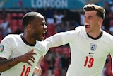 Raheem Sterling shouts with delight as Mason Mount runs in to congratulate his goal