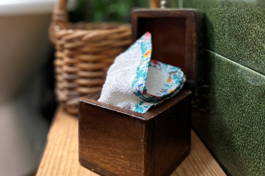 a wooden box of flannel wipes used an alternative to toilet paper