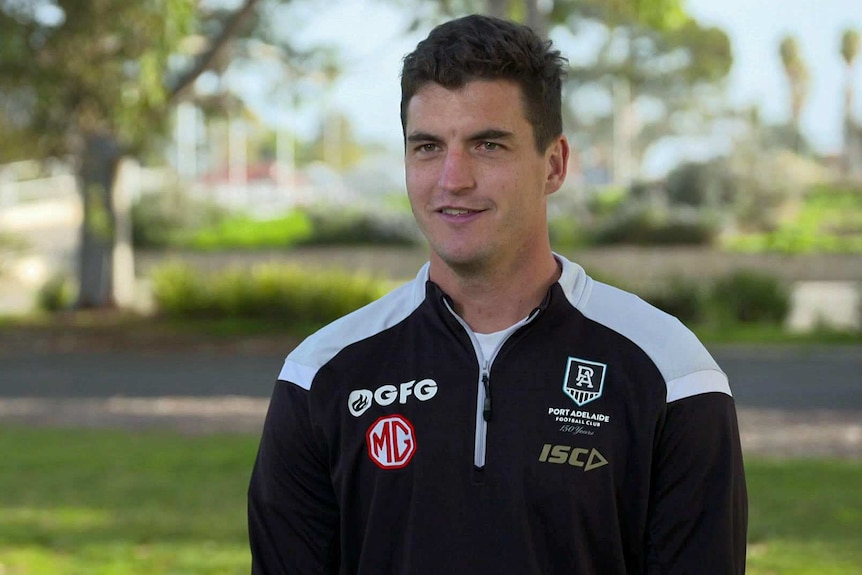 Tom Rockliff wears a Port Adelaide top.