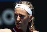 A female teniis players pups her fist after winning an Australian Open match.