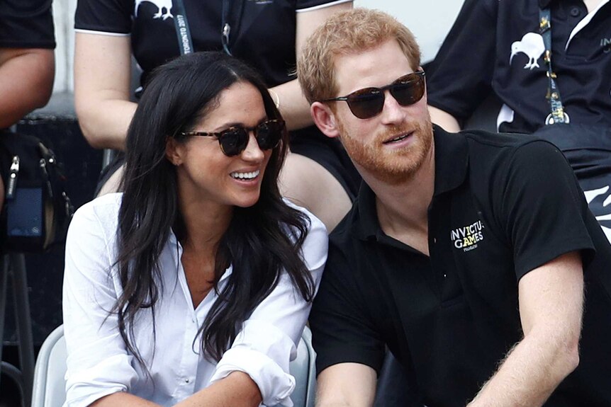 Meghan Markle smiles sitting next to Prince Harry at Invictus Games