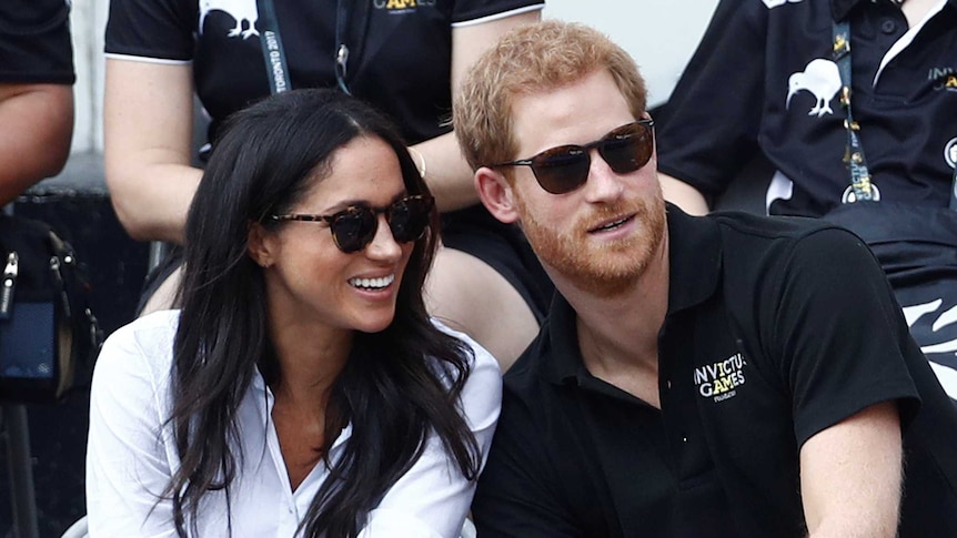 Meghan Markle smiles sitting next to Prince Harry at Invictus Games