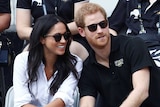 Meghan Markle smiles sitting next to Prince Harry at Invictus Games