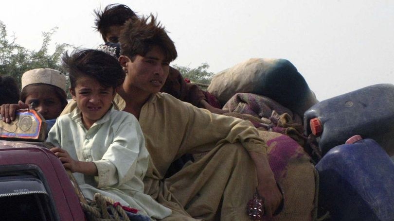 Pakistan boys flee an army attack on the Taliban