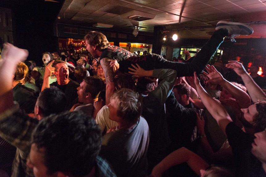 Punters go moshing and crowd surfing at local live music venues.