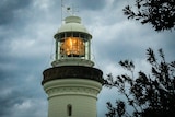 A photo of the top of a lighthouse during a storm.