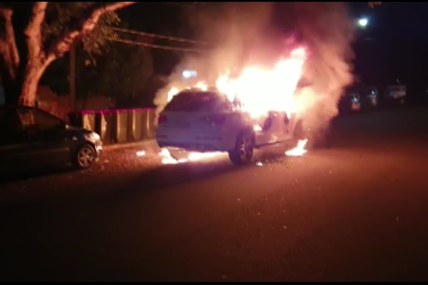 A car with fire surrounding it 