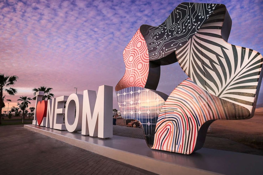 Letters spelling out "I love Neom" and a sculpture of the development body's logo.