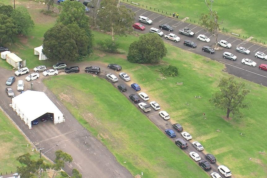 a line of cars outside a testing clinic